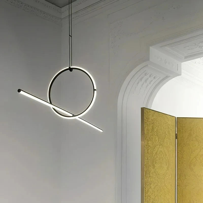 Modern pendant light hanging in a room with a gold door