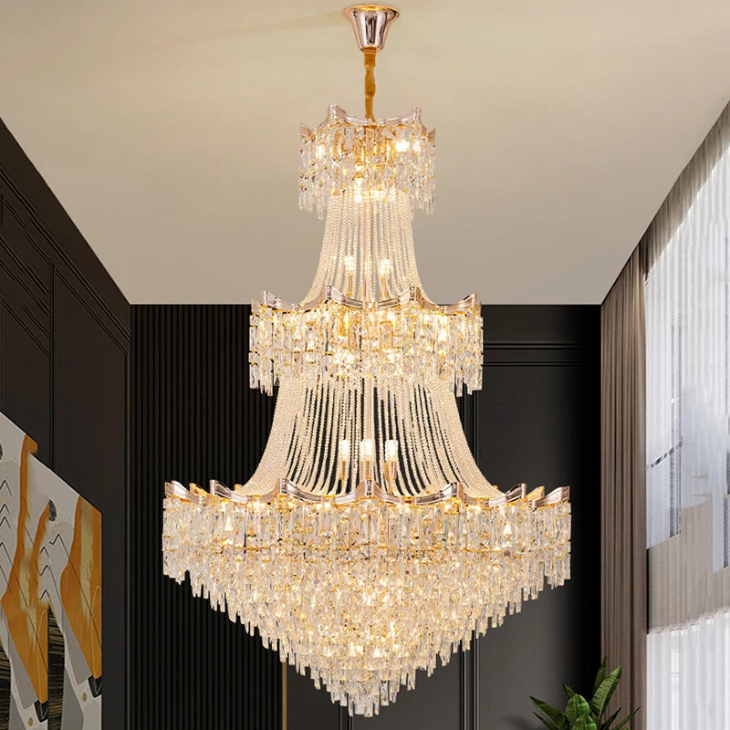 Luxurious crystal chandelier hanging in a room with dark walls and a plant.