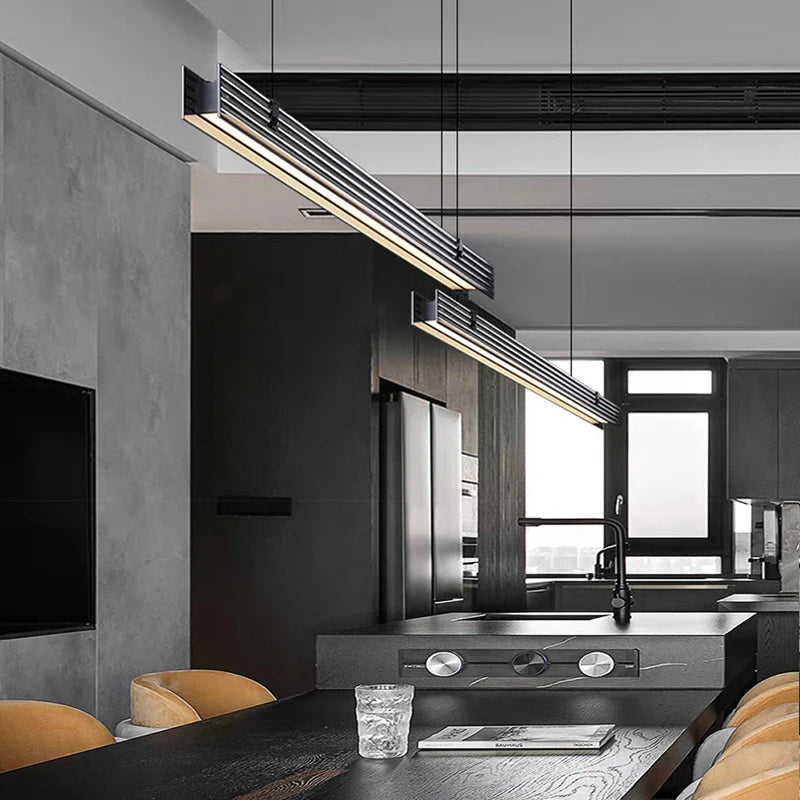 Modern kitchen with black and gray color scheme, featuring a sink and countertop.