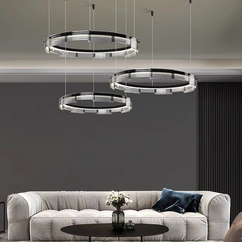 Modern pendant lights hanging above a sofa in a living room setting.