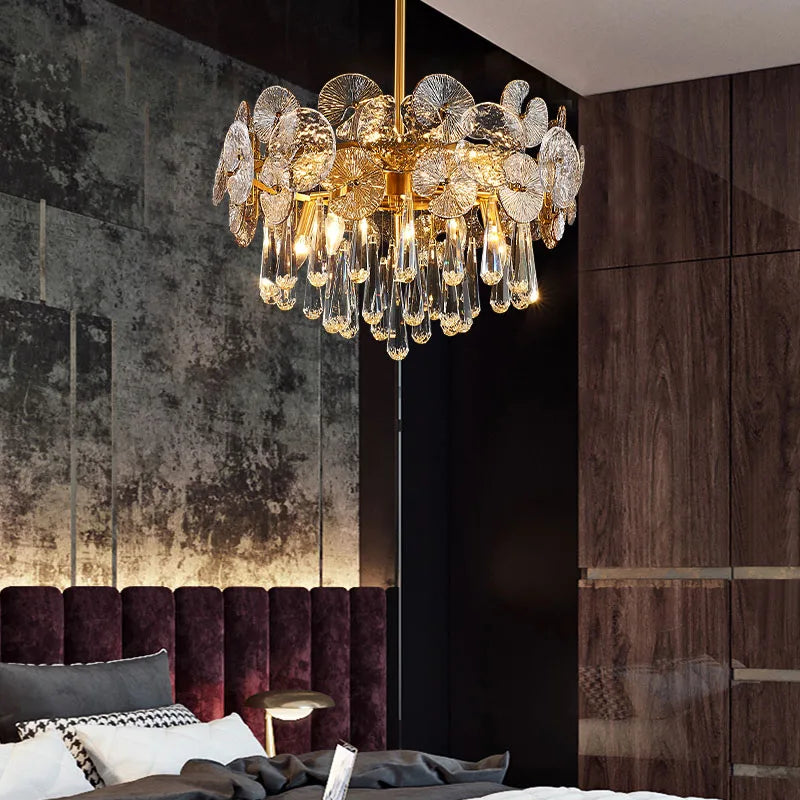 Luxury chandelier hanging in a room with a dark wall and purple headboard.