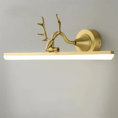 Gold wall-mounted light fixture with deer antler design on a gray background