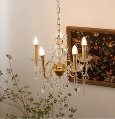 “Luxury farmhouse chandelier with crystal details and gold finish”