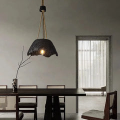 cozy dining room setup with a warm pendant light over a round table