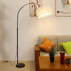 Creative feather reading and an ambient lamp for the bedroom. Living room with a floor lamp, sofa, and coffee table.
