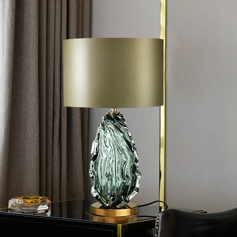 “Designer emerald glass lamp with gold base for modern interiors”