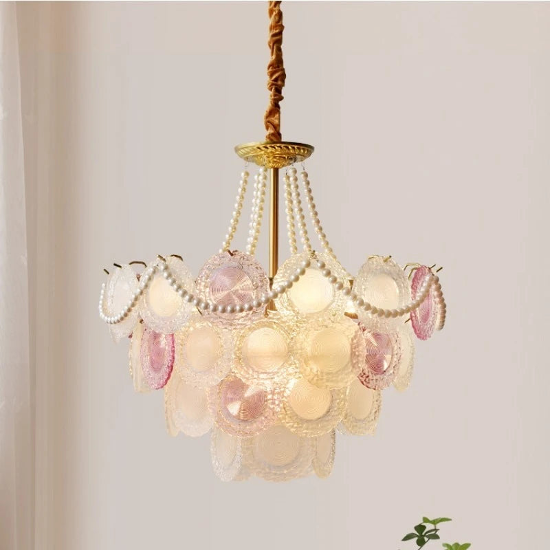 Decorative chandelier with shell-like design on a plain background