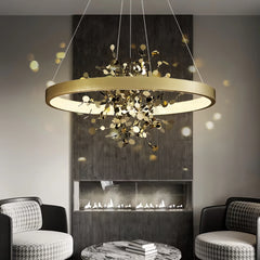 “Designer gold ring chandelier over table in modern interior”