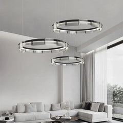 Modern living room with three circular pendant lights hanging above a sofa.