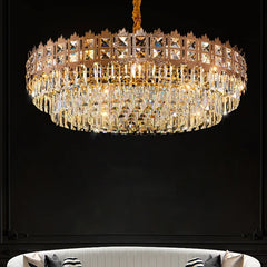 Gold chandelier with crystal accents against a black background