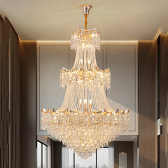 Luxurious chandelier hanging in a room with neutral walls and a window.