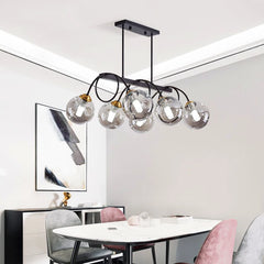 “Contemporary pendant chandelier lighting a large open-plan living space.”