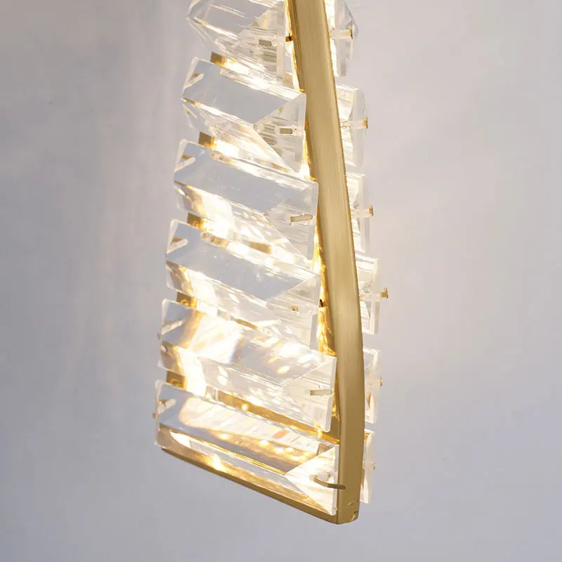 Modern pendant light with gold frame and clear glass on a gray background