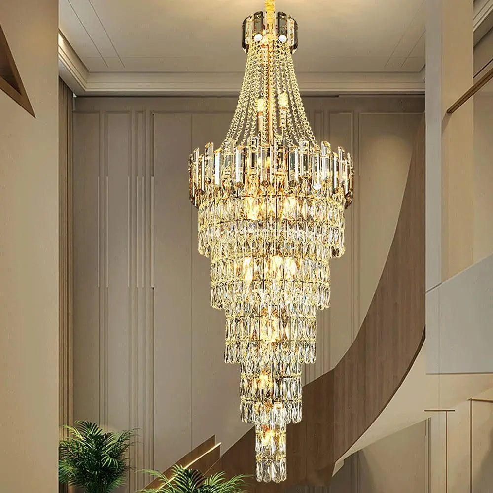 “Large cascading crystal light fixture illuminating a modern staircase”