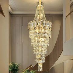 “Large cascading crystal light fixture illuminating a modern staircase”