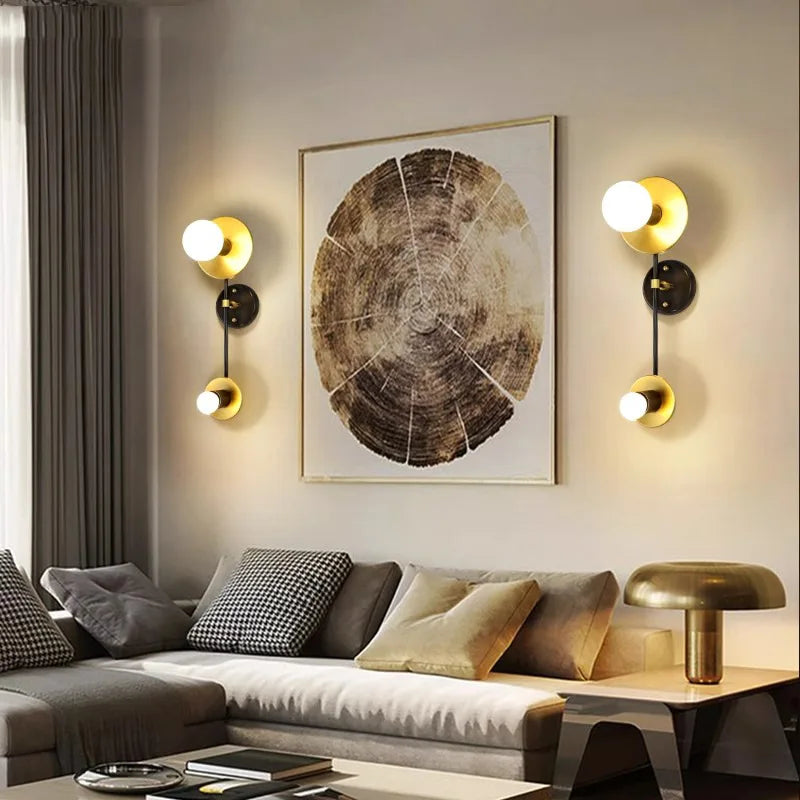 Modern living room with a tree ring wall art piece, two wall sconces, and a sofa.