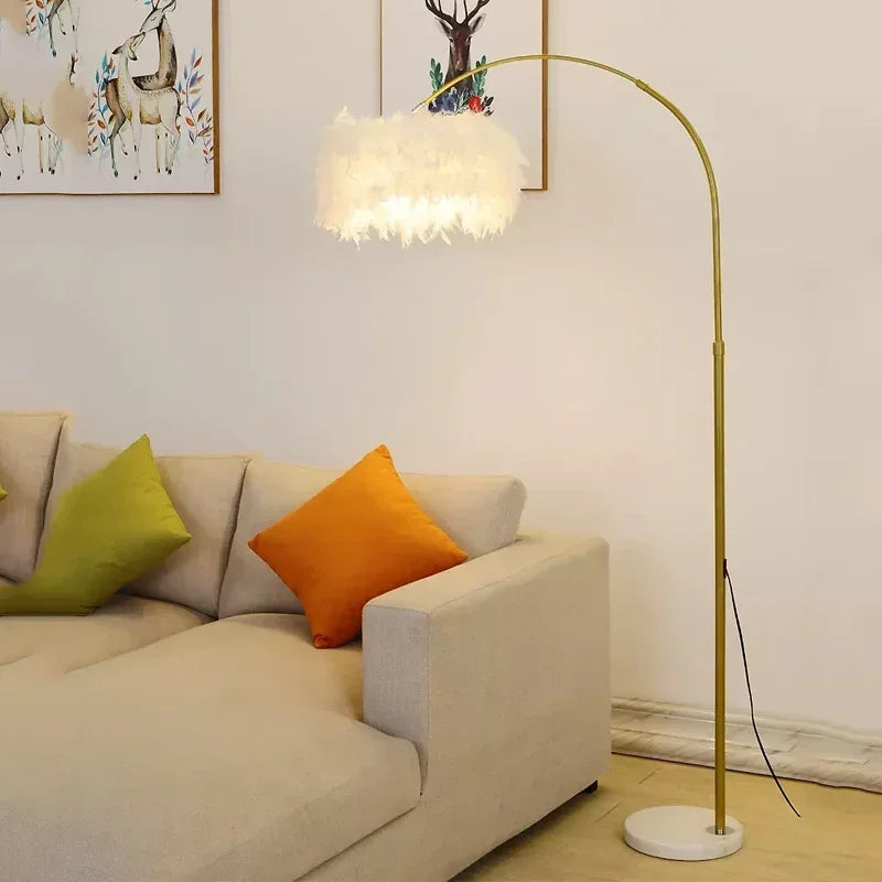 Gold feather arc floor lamp for living room or sofa corner beige sofa, orange pillow, green pillow, and a gold floor lamp. 