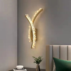 Curved wall sconce with crystal shade and up and down glow for bedroom wall lighting