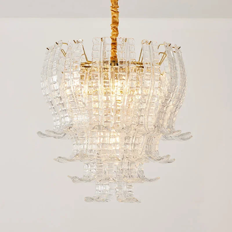 Chandelier with clear glass and gold accents on a white background