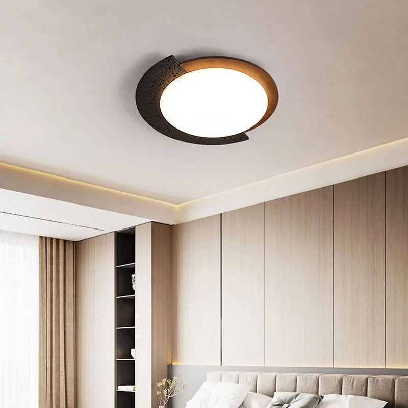 “Minimalist stone ceiling light with warm wood accent mounted on a white ceiling.”
