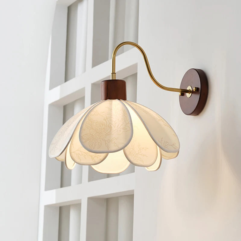 Wall-mounted lamp with floral design on a white wall