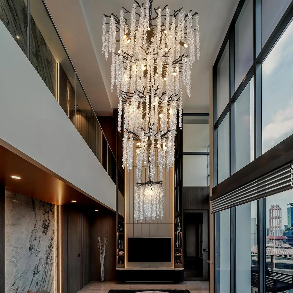 Large crystal chandelier hanging in a modern double-height interior
