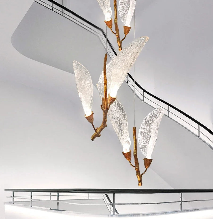 Long-drop leaf pendant chandelier cascading down a staircase space