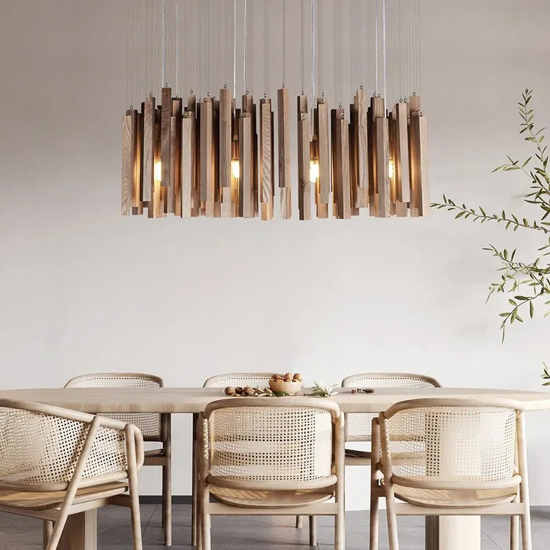 Dining area with a modern pendant light fixture, wooden table, and chairs.