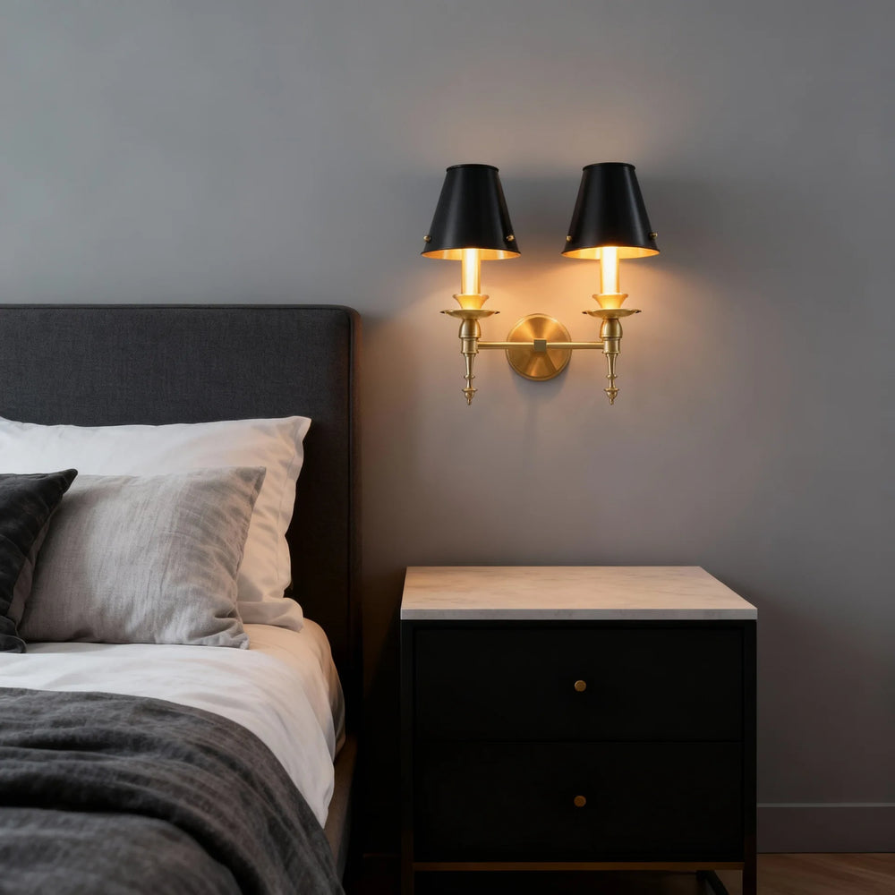 Modern bedroom with a bed, nightstand, and wall sconces.
