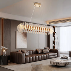 “Liglite gold chandelier over living room with geometric accents”