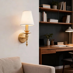 Wall-mounted lamp with a desk and books in the background