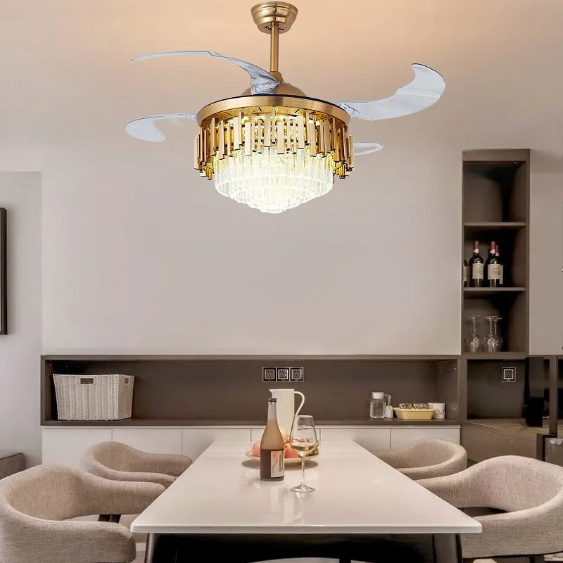 “Modern retractable-blade chandelier fan illuminating a beige bedroom.”