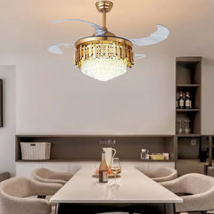 “Modern retractable-blade chandelier fan illuminating a beige bedroom.”