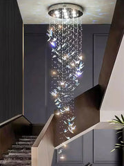 Large crystal chandelier cascading down a staircase in a modern interior