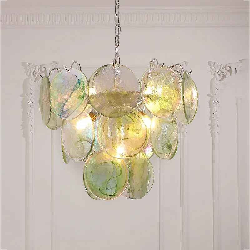 Decorative chandelier with glass discs on a white wall background . Luxury multicolor glass chandelier for hotel and villa