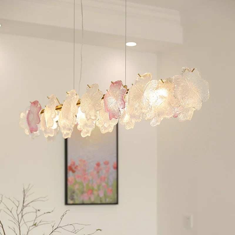 Decorative chandelier with floral design in a room with a painting on the wall.