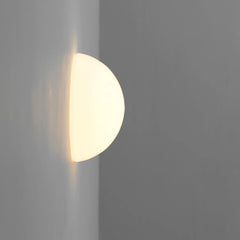 Modern wall-mounted light fixture on a gray wall