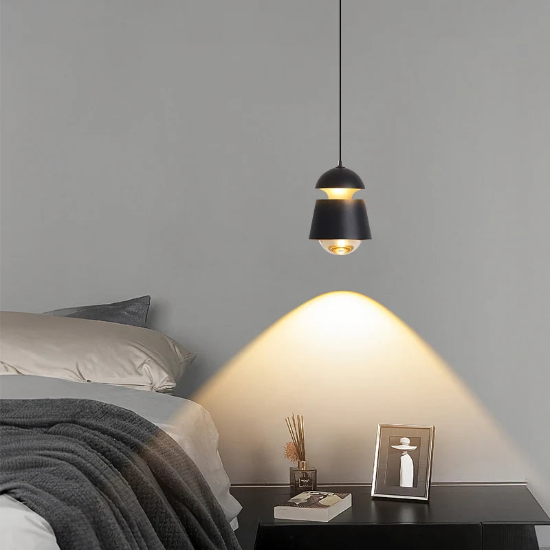 Minimalist bedside pendant light hanging above a nightstand area
