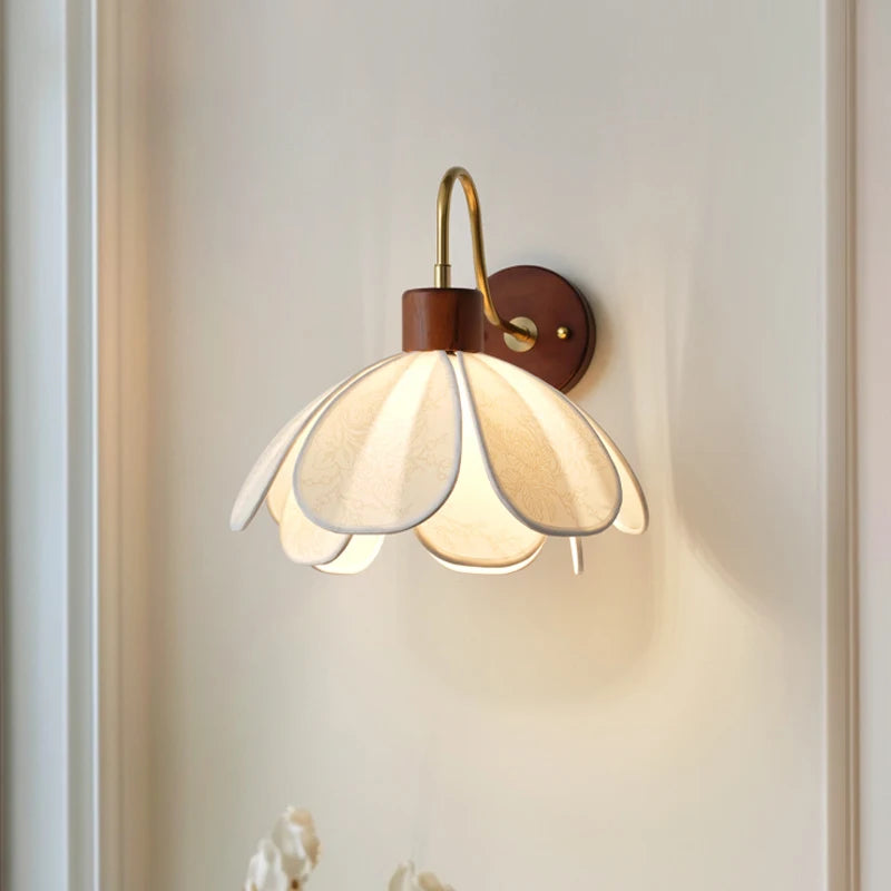 Wall-mounted lamp with floral design on a light gray wall