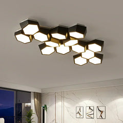 Modern ceiling light fixture with a hexagonal design in a room with marble walls and a window.
