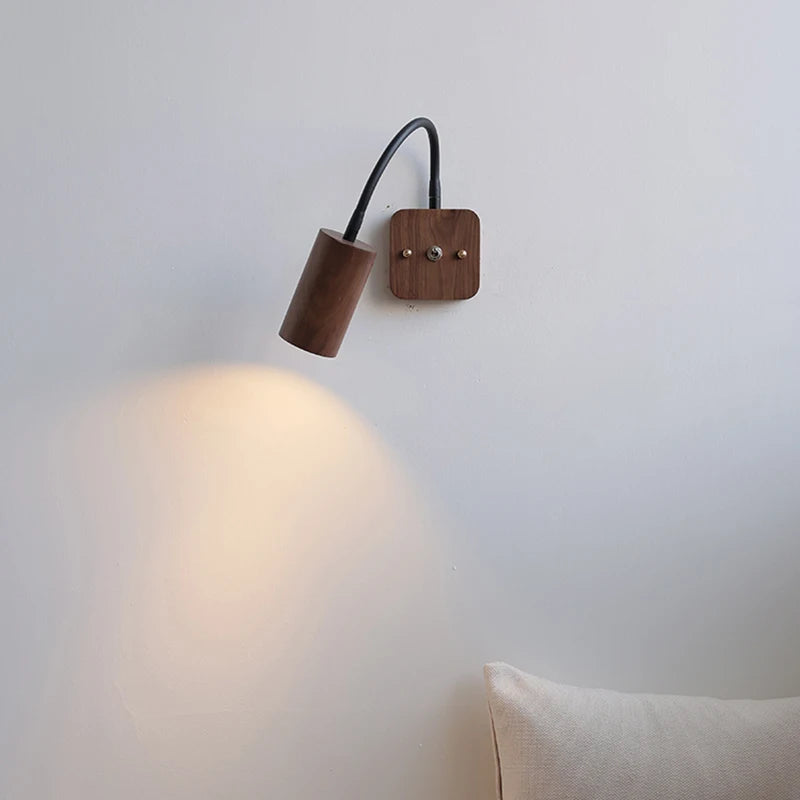 Wooden wall lamp with a light on a white wall