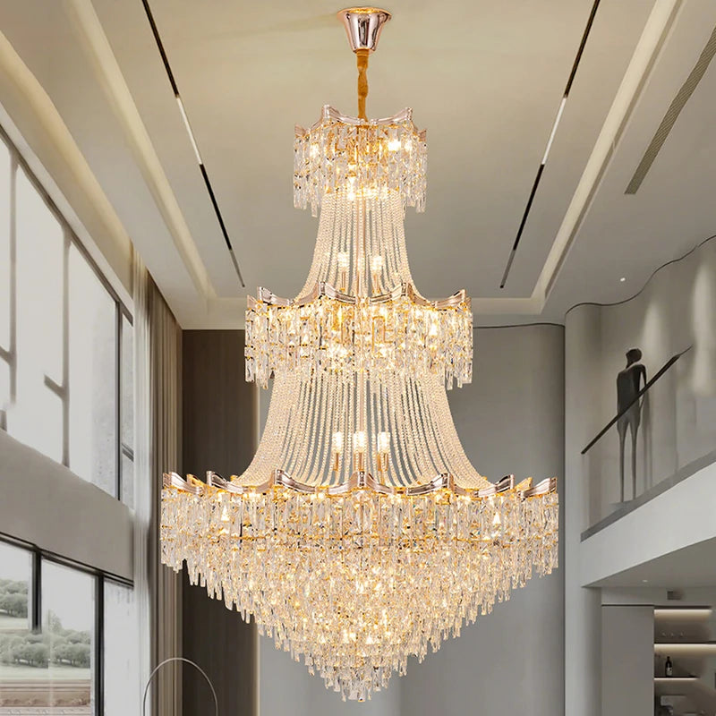 Luxurious chandelier hanging in a modern indoor setting with large windows.