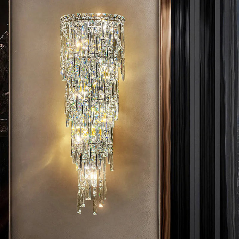 Crystal wall sconce on a neutral wall with a black curtain.