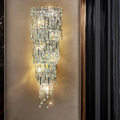 Crystal wall sconce on a neutral wall with a black curtain.