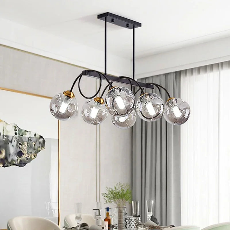 “Modern dimmable globe chandelier with black frame and gold accents.”