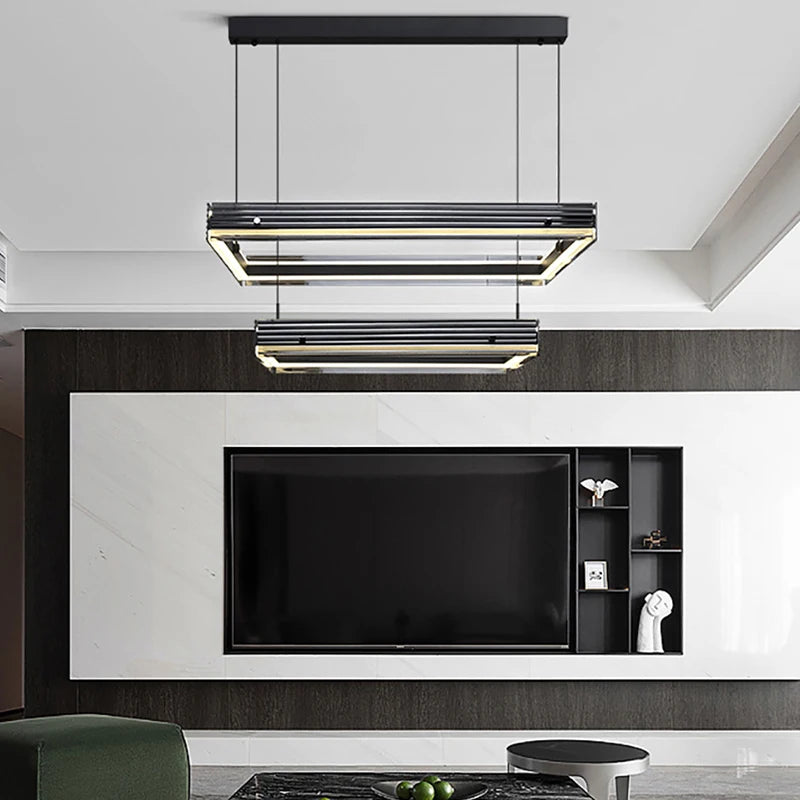 Modern living room with a television and pendant lights.