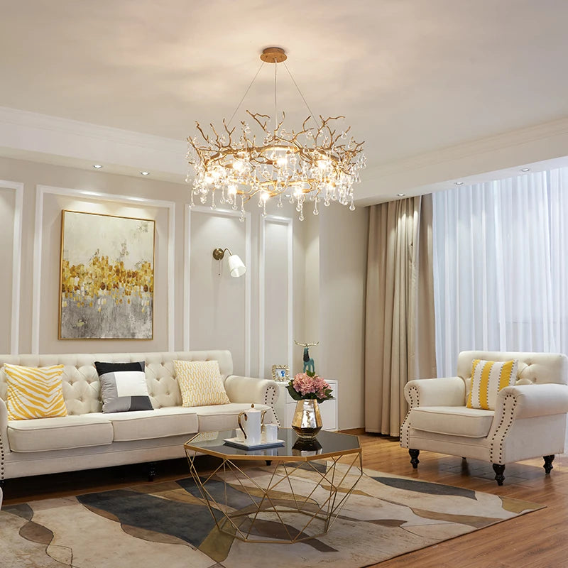 Modern living room with a chandelier, sofa, and armchair. Designer luxury ceiling statement fixture for an artful large dining or lounge.