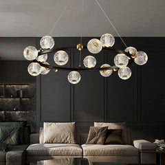 Modern multi-globe pendant chandelier in alloy above a luxury sofa