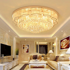 Luxurious living room with a large chandelier, sofa, and decorative elements.