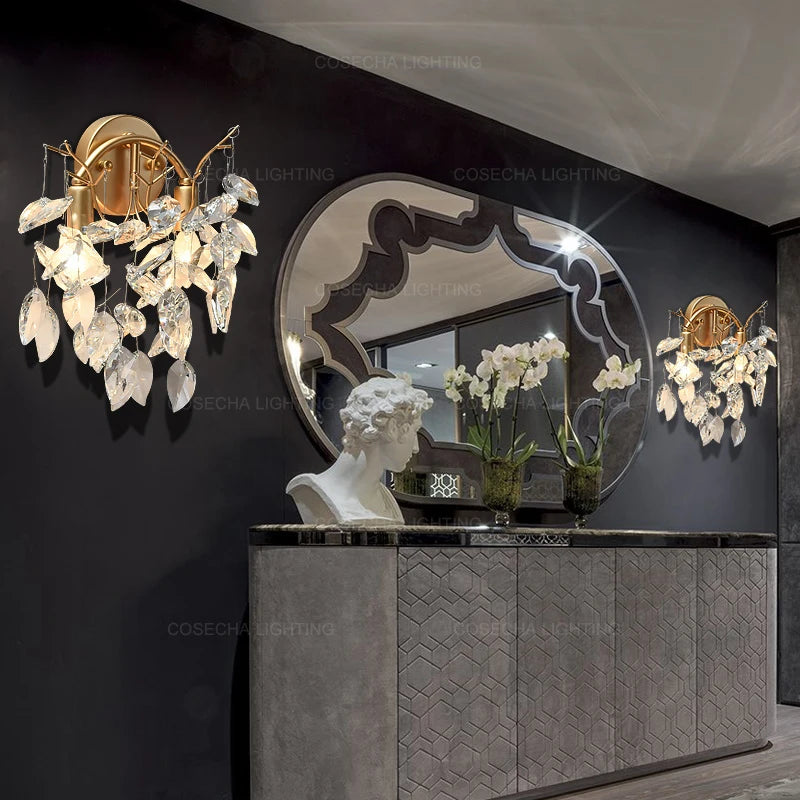 Decorative wall lights with floral design on a dark wall with a mirror and bust.